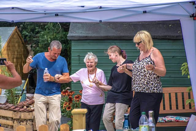 Visitors dancing at the opening of the allotment.