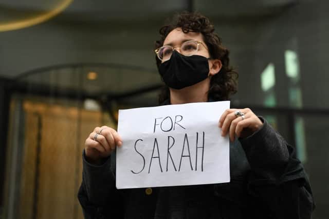 A woman holds a placard outside the Old Bailey court on the second day of the sentencing of police officer Wayne Couzens for the murder of Sarah Everard. (Photo by DANIEL LEAL-OLIVAS / AFP)