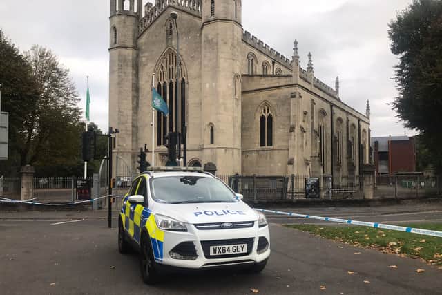Police car outside Trinity Church in Bristol after a teenager died in Lawrence Hill