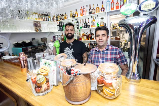 <p>Suat "Sam" Tezgel (right) and barman Coskun Aklan</p>