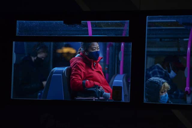 People wearing protective face masks are seen on a bus in Bristol (Photo by Finnbarr Webster/Getty Images)