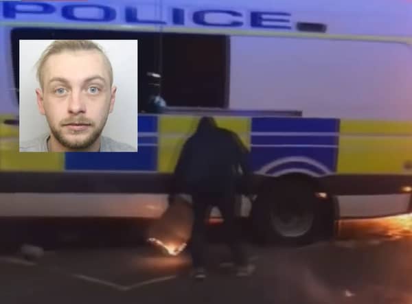 Footage shown to the jury showed Roberts holding a piece of burning cardboard under a police van as it reversed. Seven officers were inside the vehicle at the time.