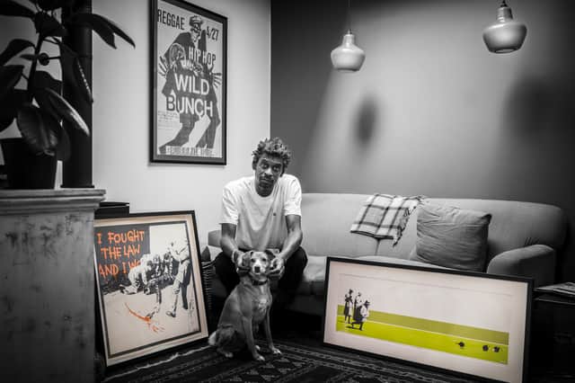 <p>Daddy G of Massive Attack, also known as Grant Marshall, with the two prints he donated to the auction</p>