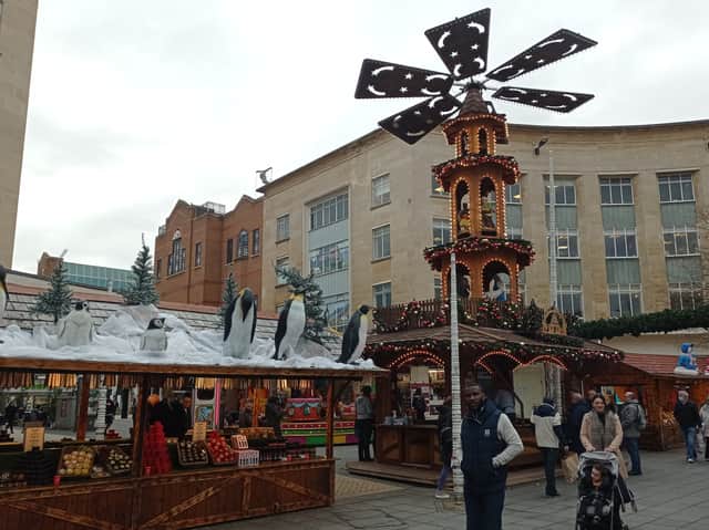Shoppers wander through the Christmas market on its day of opening