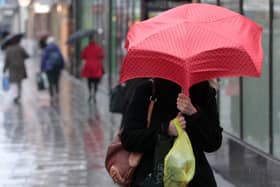 Shoppers pictured in Bristol city centre during heavy rain recently.