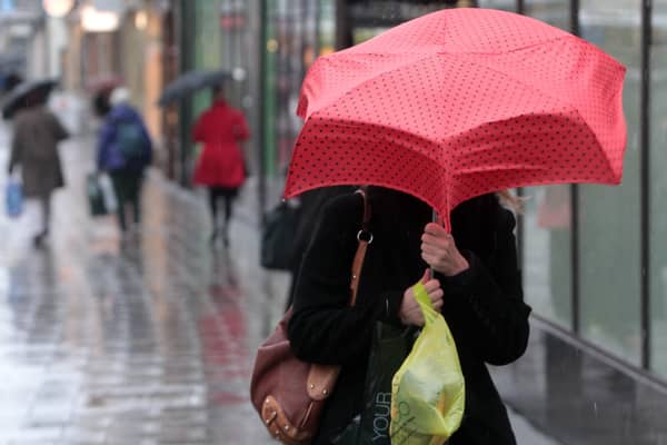 Shoppers pictured in Bristol city centre during heavy rain recently.