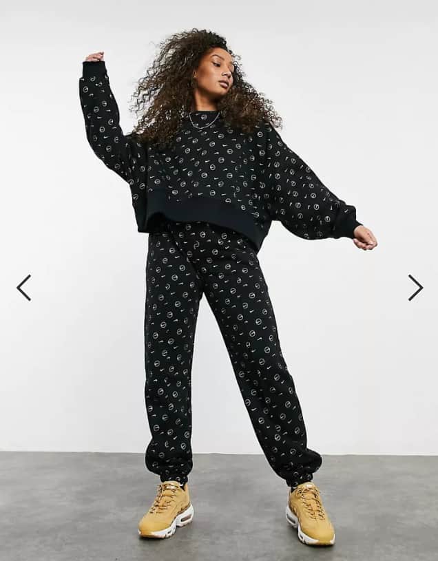 Nike all over logo print tracksuit in black. (Pic: Asos)
