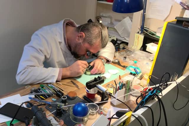 Watchmaker German Polosin at work in his watch shop in The Arcade.