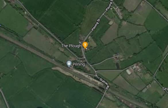 Pilning Railway Station is surrounded by fields. The Plough pub is nearby.