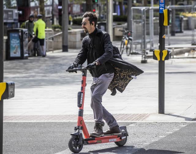 People ride e-scooters across Bristol City Centre