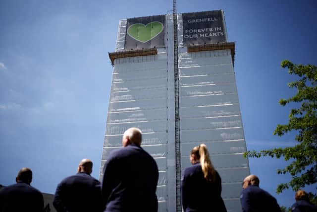 Firefighters pay their respects at a memorial to the victims of the Grenfell Tower fire in London, four years after the fire in the residential tower block killed 72 people. 