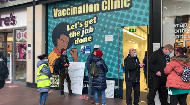 <p>People wait to have their booster jab outside the walk-in clinic at Cabot Circus</p>