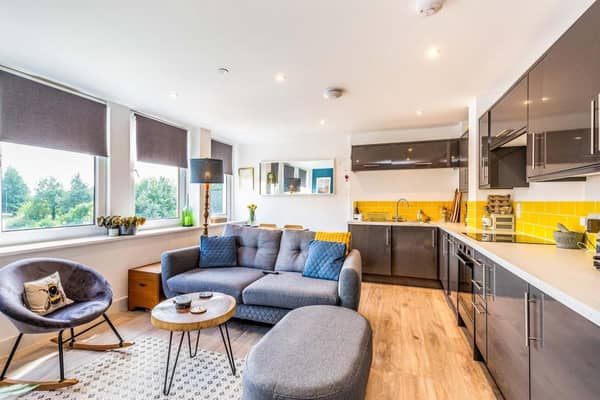 The flat has a modern interior with wooden-style flooring