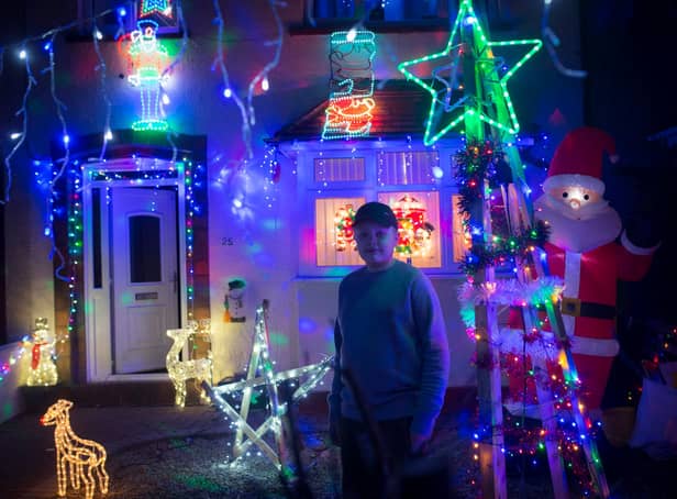 <p>Jake Skinner in front of the festive light display in honour of sister who died on Christmas Day</p>