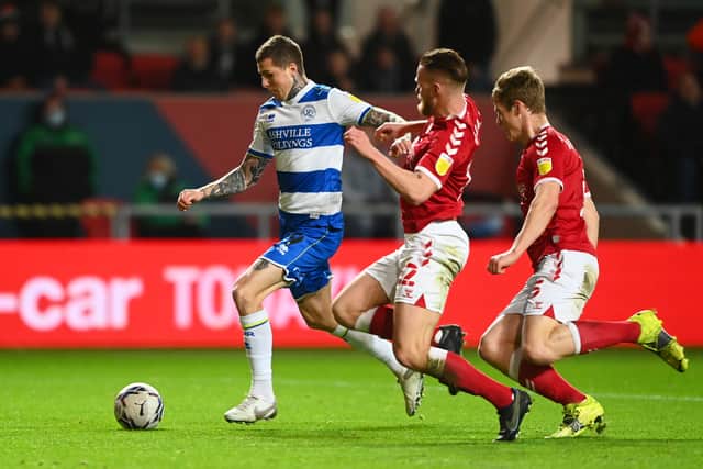Lyndon Dykes of Queens Park Rangers holds off Max O’Leary and Rob Atkinson during his side’s last-gasp win at Ashton Gate