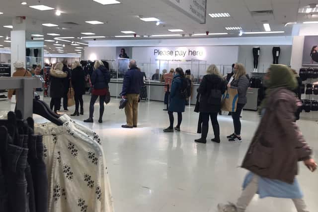 People queue up for probably their last purchase at M&S in Broadmead