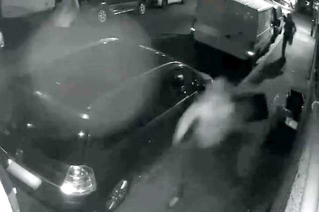 The victim pushes over a rubbish bin as he tries to escape
