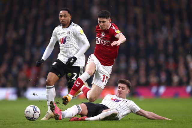 Callum O’Dowda is tackled by Tom Cairney at Craven Cottage.