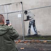 A stenciled figure of a man with a crowbar has appeared on an original Banksy in Barton Hill