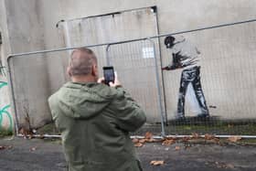 A stenciled figure of a man with a crowbar has appeared on an original Banksy in Barton Hill