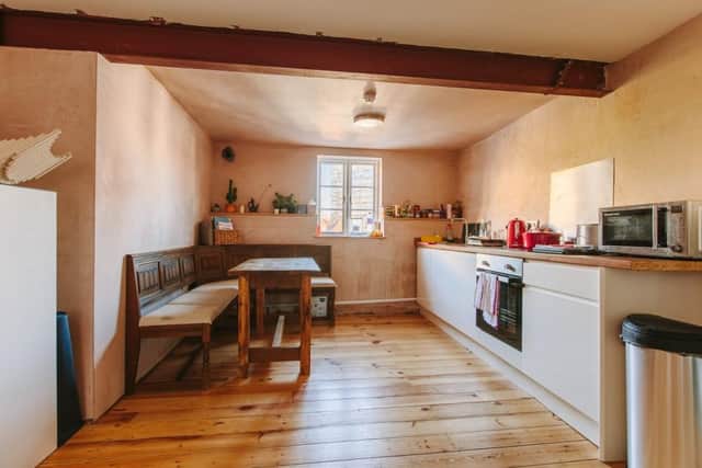 The home has a large kitchen area with exposed wooden beams