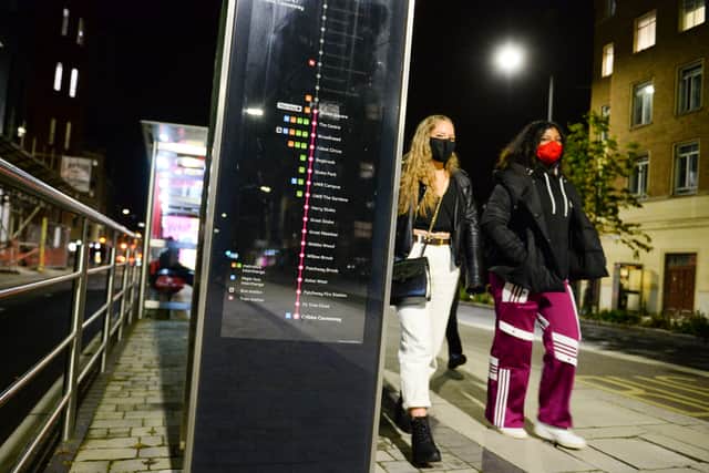 Students walk past a bus stop in Bristol.