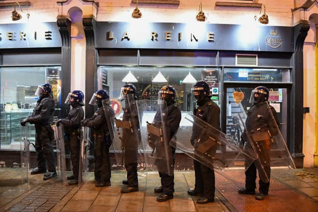  Riot police stand on patrol during a protest in Bristol.