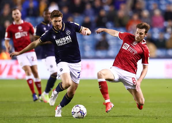 George Evans of Millwall battles for possession with Joe Williams of Bristol City.