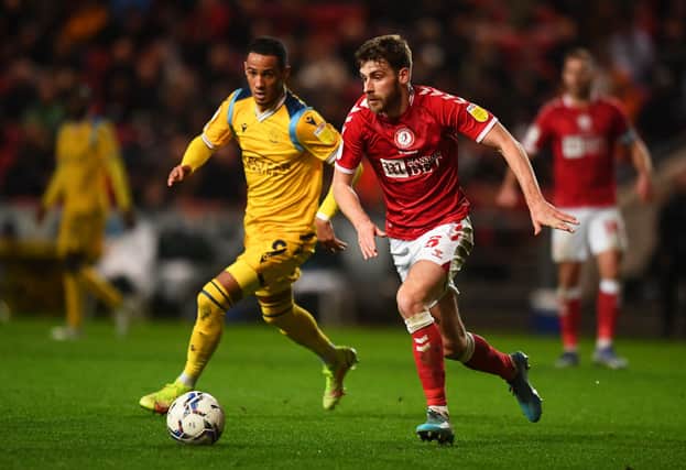 Joe Williams of Bristol City battles for possession with Tom Ince of Reading.