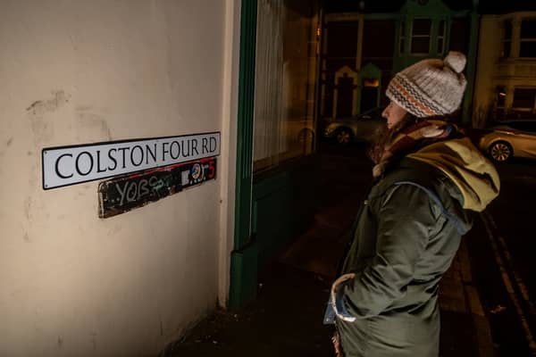 A woman looks at the new Colston Four Road sign, put up in Easton over the weekend