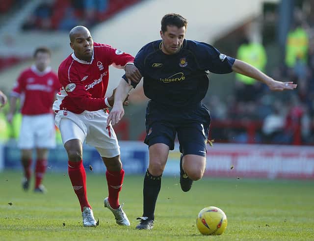 Marlon King of Nottingham Forest holds on to Ian Pearce of West Ham, back in 2003.