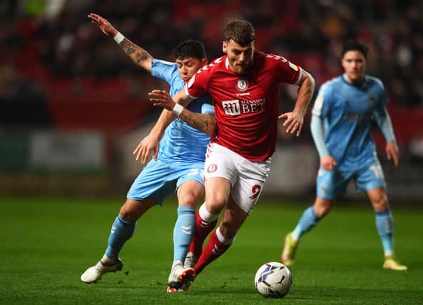 Chris Martin of Bristol City battles for possession with Gustavo Hamer of Coventry City.