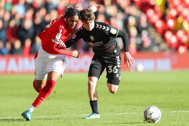 Djed Spence of Nottingham Forest battles for possession with Alex Scott of Bristol City.