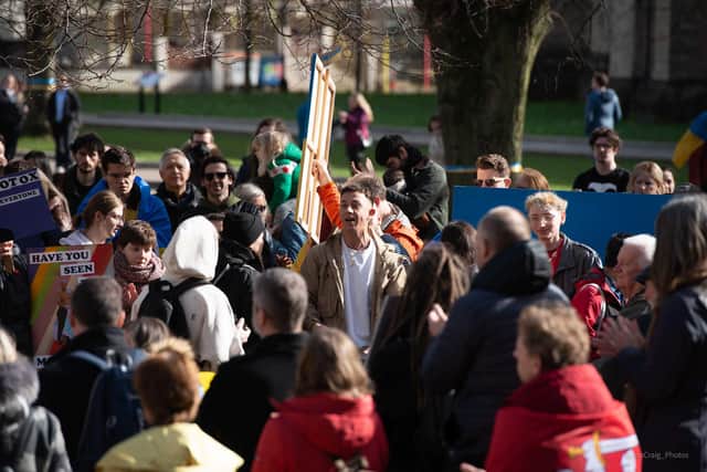 Yaroslav stands surrounded by Bristol residents showing solidarity with Ukraine. Image by Jon Craig Photography.
