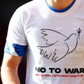 Birmingham City players wear t-shirts displaying the message ‘no to war’ before facing Bristol City.