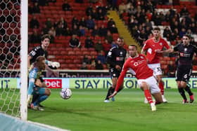 Carlton Morris of Barnsley scores their side’s first goal past Daniel Bentley of Bristol City.