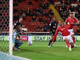 Carlton Morris of Barnsley scores their side’s first goal past Daniel Bentley of Bristol City.