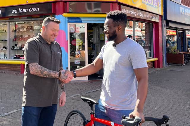 Didun Obilande reuniting with Baz from Cash Converters after his bike was returned 