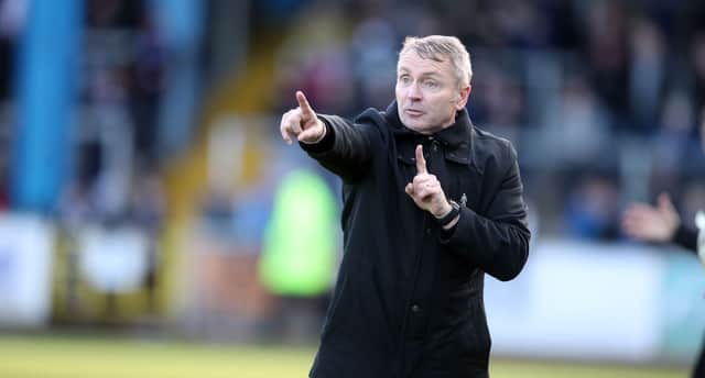 Carlisle United manager Paul Simpson gives instructions.