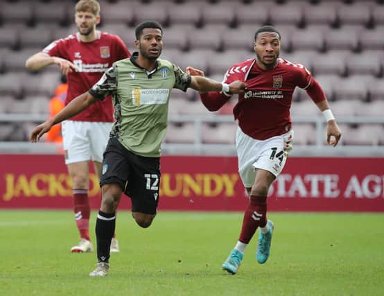 Owura Edwards of Colchester United, left, and Ali Koiki  of Northampton Town