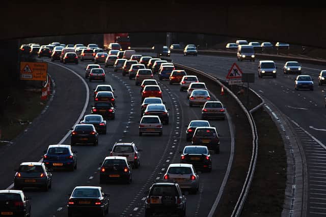 Congested commuter traffic queue as they pass junction 18 on the M4 motorway at rush hour near Bristol. Is an Underground railway the answer to a better commute in and out of the city?