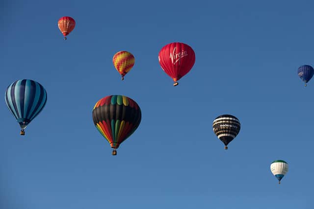 Hot air balloons rise into the morning sky from the Bristol International Balloon Fiesta.