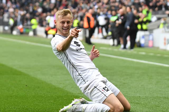 Harry Darling celebrates his first class goal against Morecambe at Stadium MK. It was the defender’s ninth goal of the season, and put them in pole position to take the three points on Saturday.