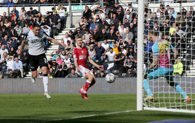 <p>Craig Forsyth (L) of Derby heads to score during Bristol City’s win at Derby County.</p>