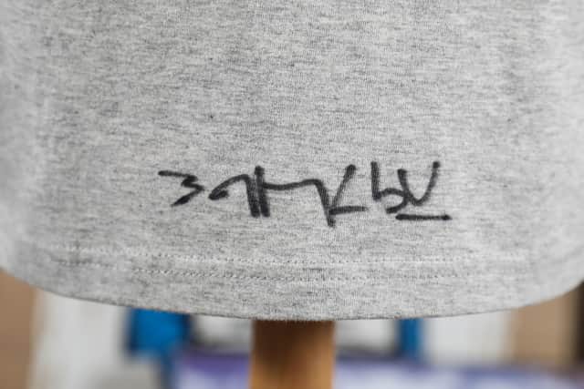 Banksy’s signature on the back of the T-shirt