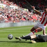 Jacob Brown of Stoke City is challenged by Rob Atkinson of Bristol City.