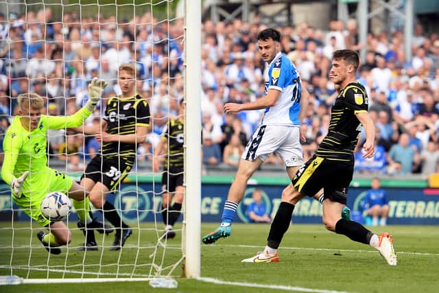 Aaron Collins heads in the sixth goal as Rovers won 7-nil and achieved promotion