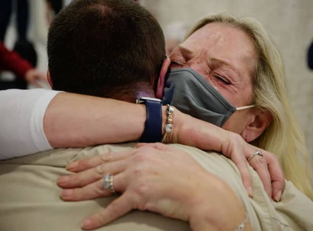 <p>Alison Henry embraces her son Liam (Photo by ED JONES/AFP via Getty Images)</p>