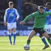 Lewis Baker of Stoke City is challenged by Jeando Fuchs of Peterborough United.