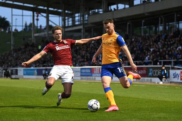 <p>Rhys Oates of Mansfield Town is tackled by Fraser Horsfall of Northampton Town.</p>